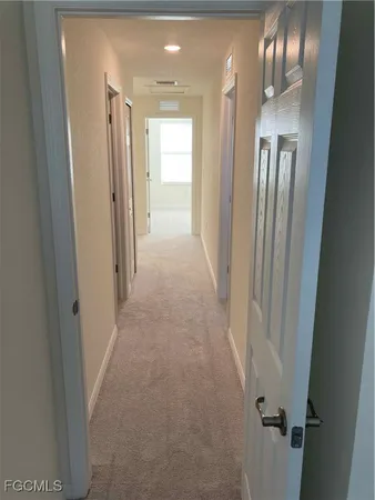 a view of a hallway with wooden shelves