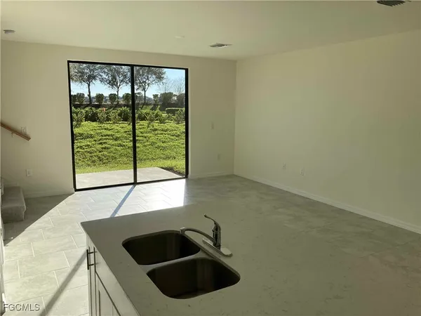 a kitchen with a sink and large window