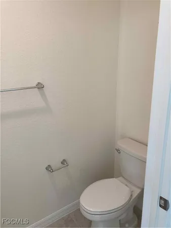 a white toilet sitting next to a shower