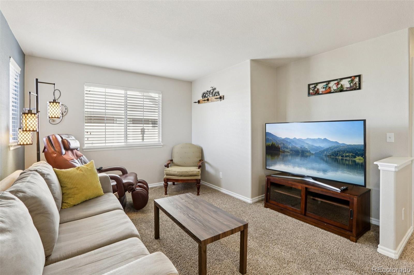 3120 Redhaven Way Highlands Ranch, CO 80126 - Photo 14 of 50 a living room with furniture and a flat screen tv