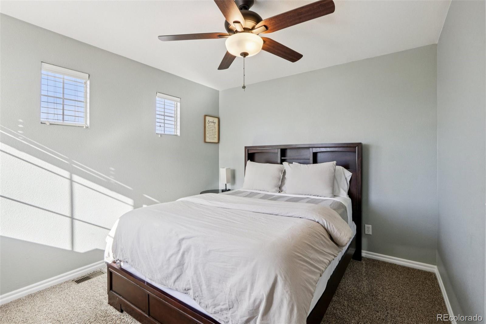 3120 Redhaven Way Highlands Ranch, CO 80126 - Photo 15 of 50 a bedroom with a bed and a ceiling fan