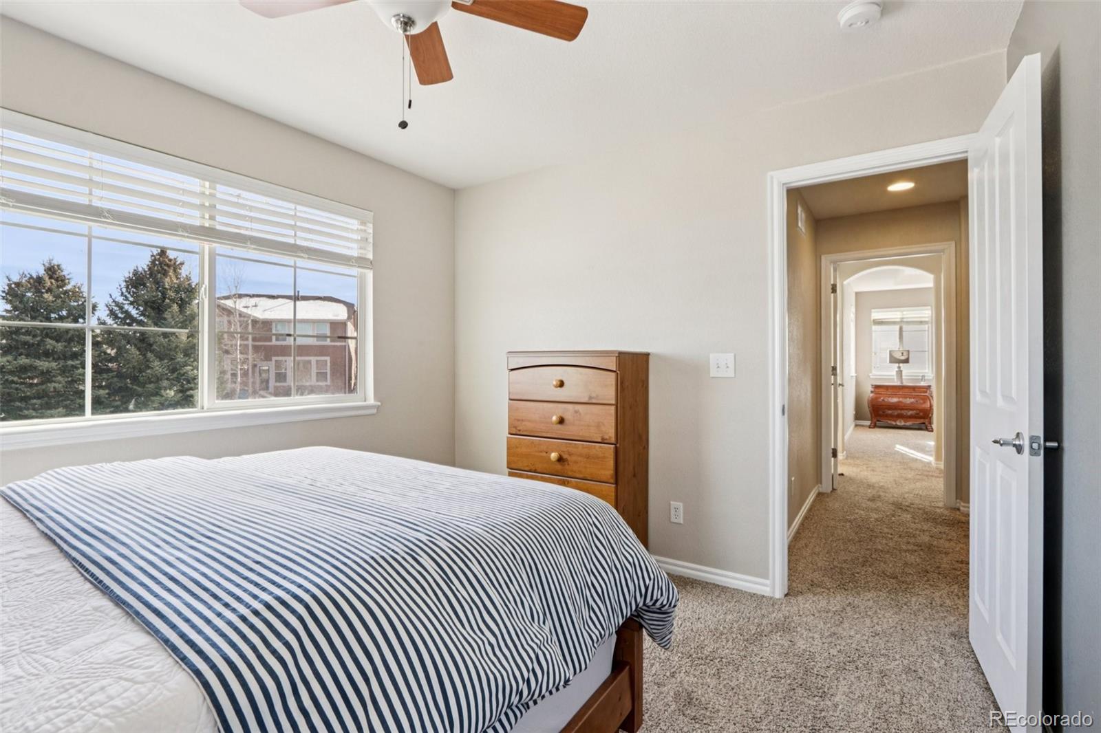3120 Redhaven Way Highlands Ranch, CO 80126 - Photo 18 of 50 a bedroom with a bed and a dresser