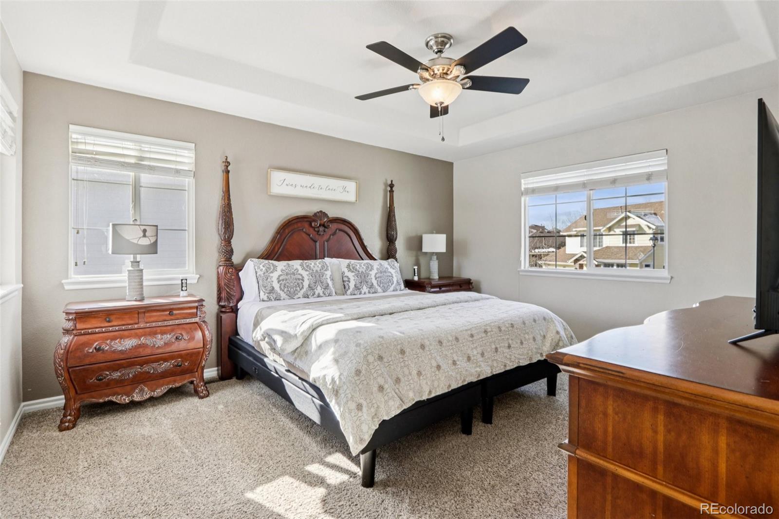 3120 Redhaven Way Highlands Ranch, CO 80126 - Photo 19 of 50 a bedroom with a bed and a chandelier