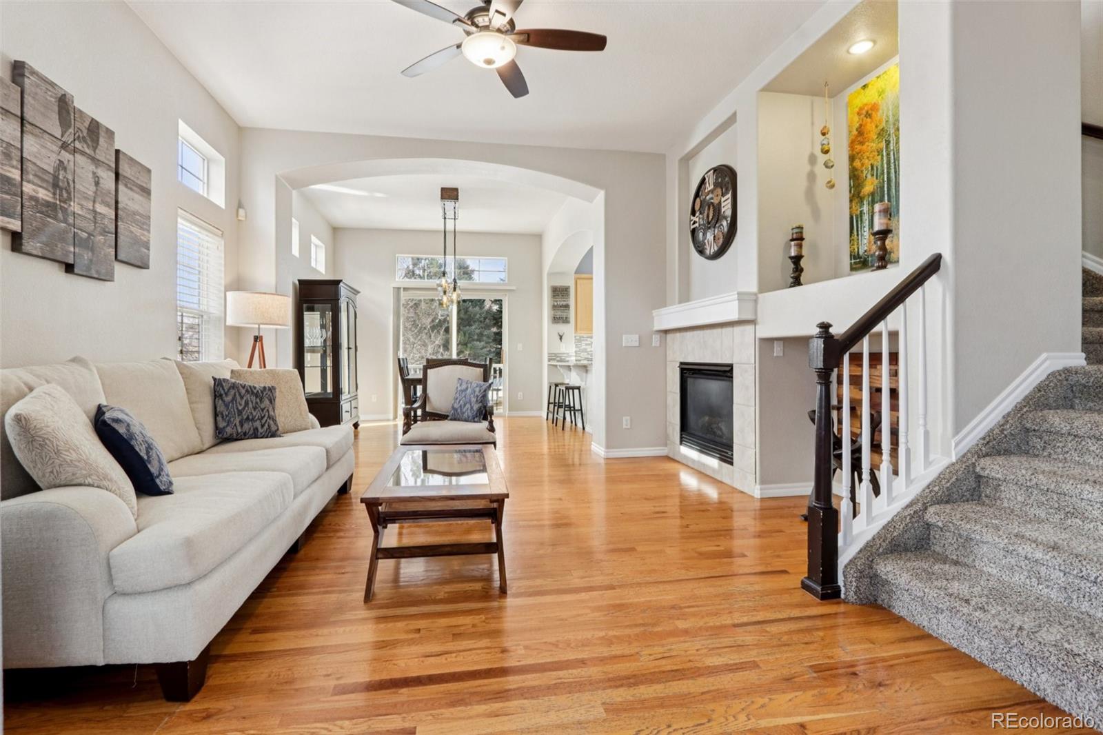 3120 Redhaven Way Highlands Ranch, CO 80126 - Photo 2 of 50 a living room with fireplace furniture and a wooden floor