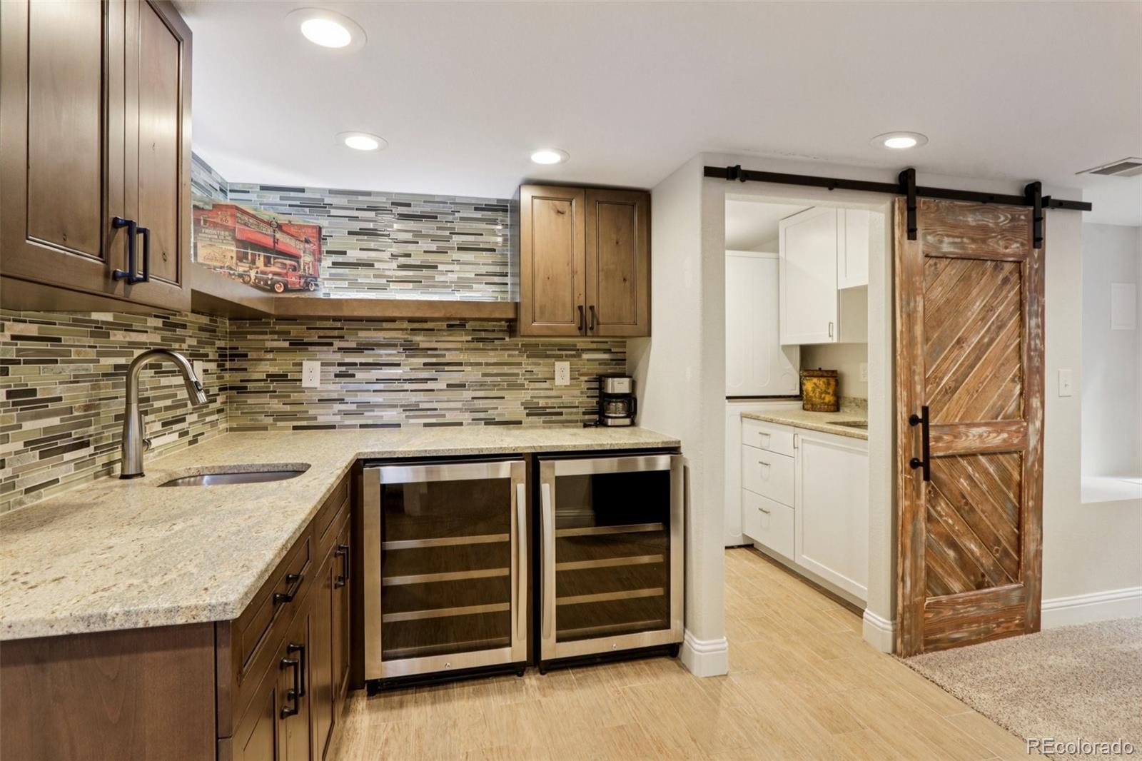 3120 Redhaven Way Highlands Ranch, CO 80126 - Photo 24 of 50 a kitchen with stainless steel appliances granite countertop a sink and refrigerator