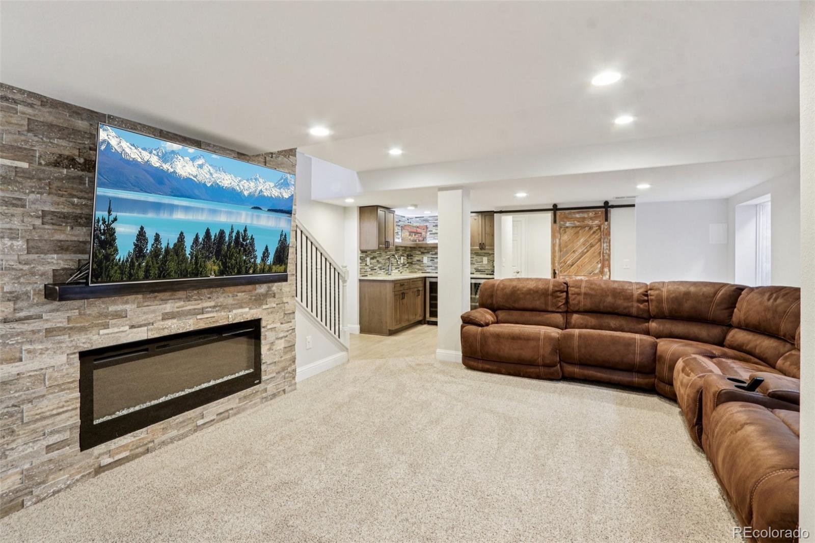 3120 Redhaven Way Highlands Ranch, CO 80126 - Photo 25 of 50 a living room with furniture and a kitchen