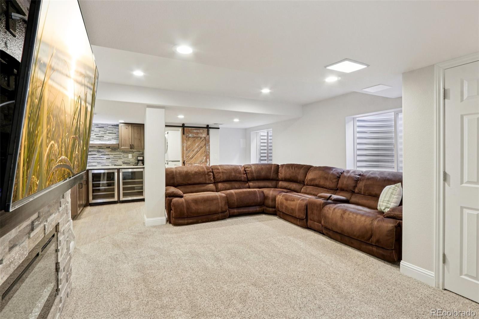 3120 Redhaven Way Highlands Ranch, CO 80126 - Photo 26 of 50 a living room with a couch and a flat screen tv