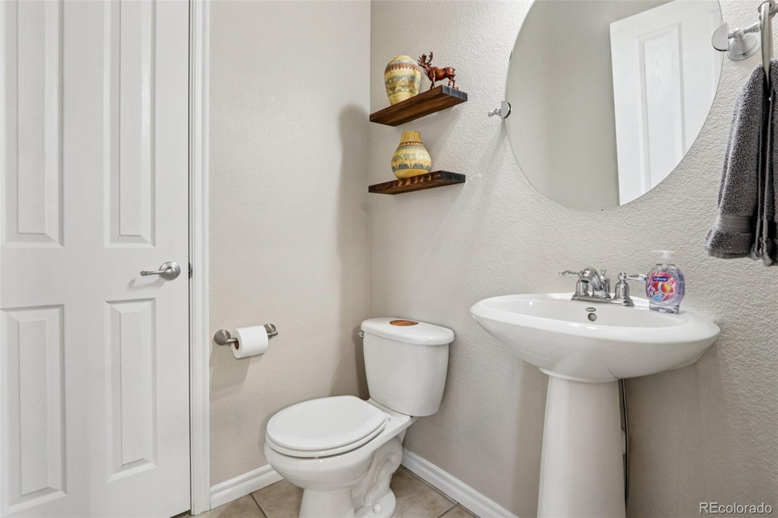 3120 Redhaven Way Highlands Ranch, CO 80126 - Photo 30 of 50 a bathroom with a sink toilet and mirror