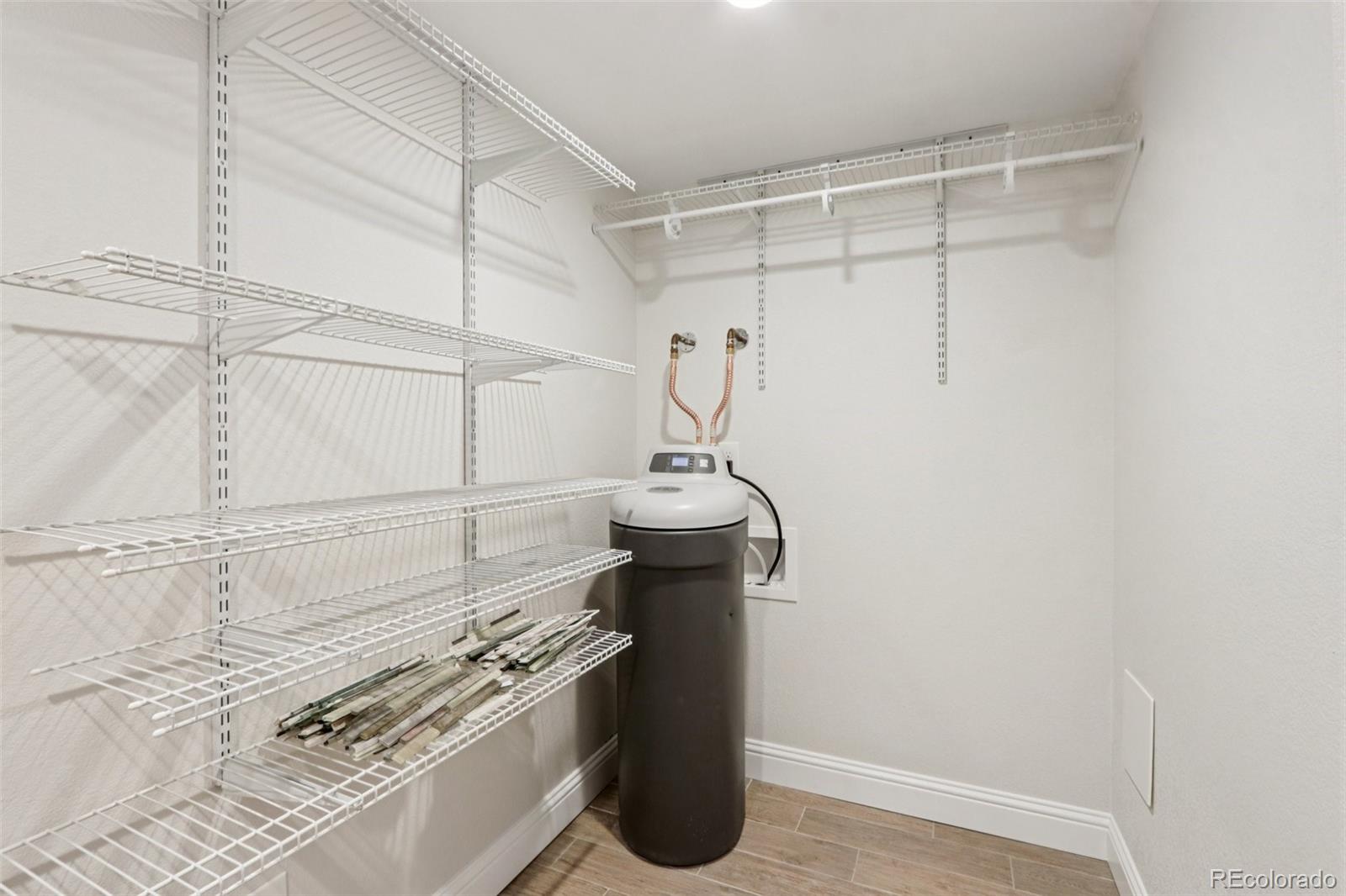 3120 Redhaven Way Highlands Ranch, CO 80126 - Photo 39 of 50 a kitchen with a sink and wooden floor