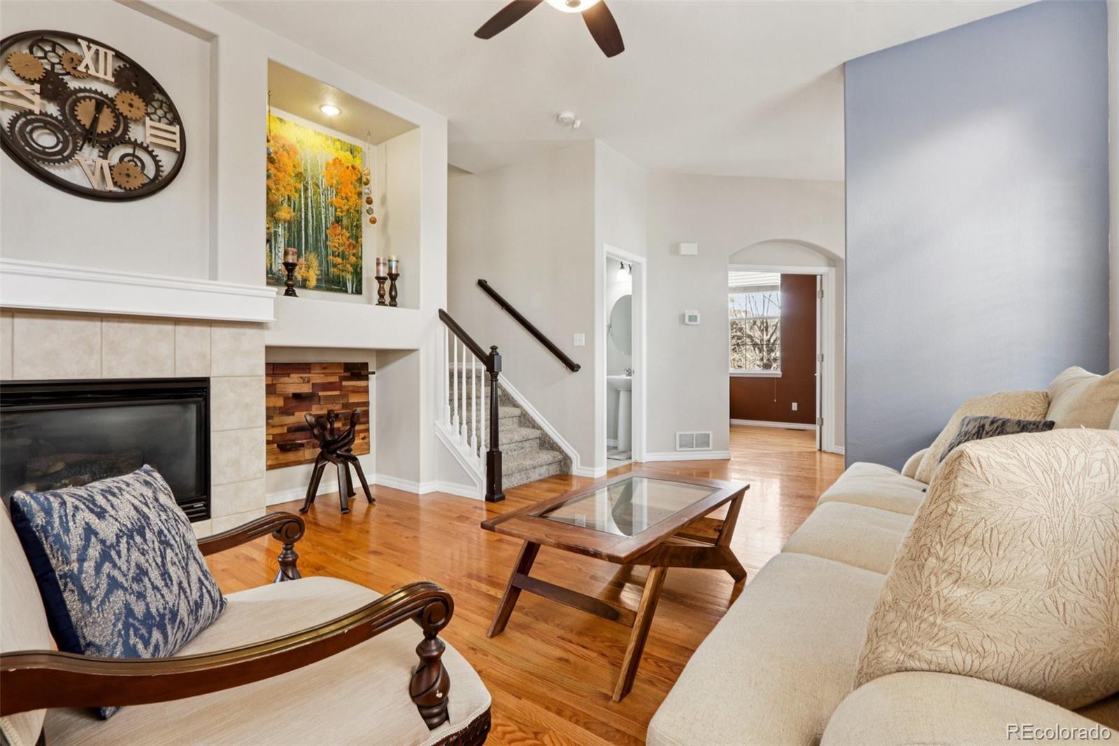 3120 Redhaven Way Highlands Ranch, CO 80126 - Photo 4 of 50 a living room with furniture and a fireplace