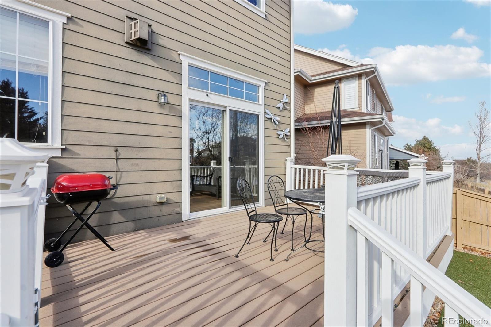 3120 Redhaven Way Highlands Ranch, CO 80126 - Photo 47 of 50 a view of a house with wooden deck and furniture