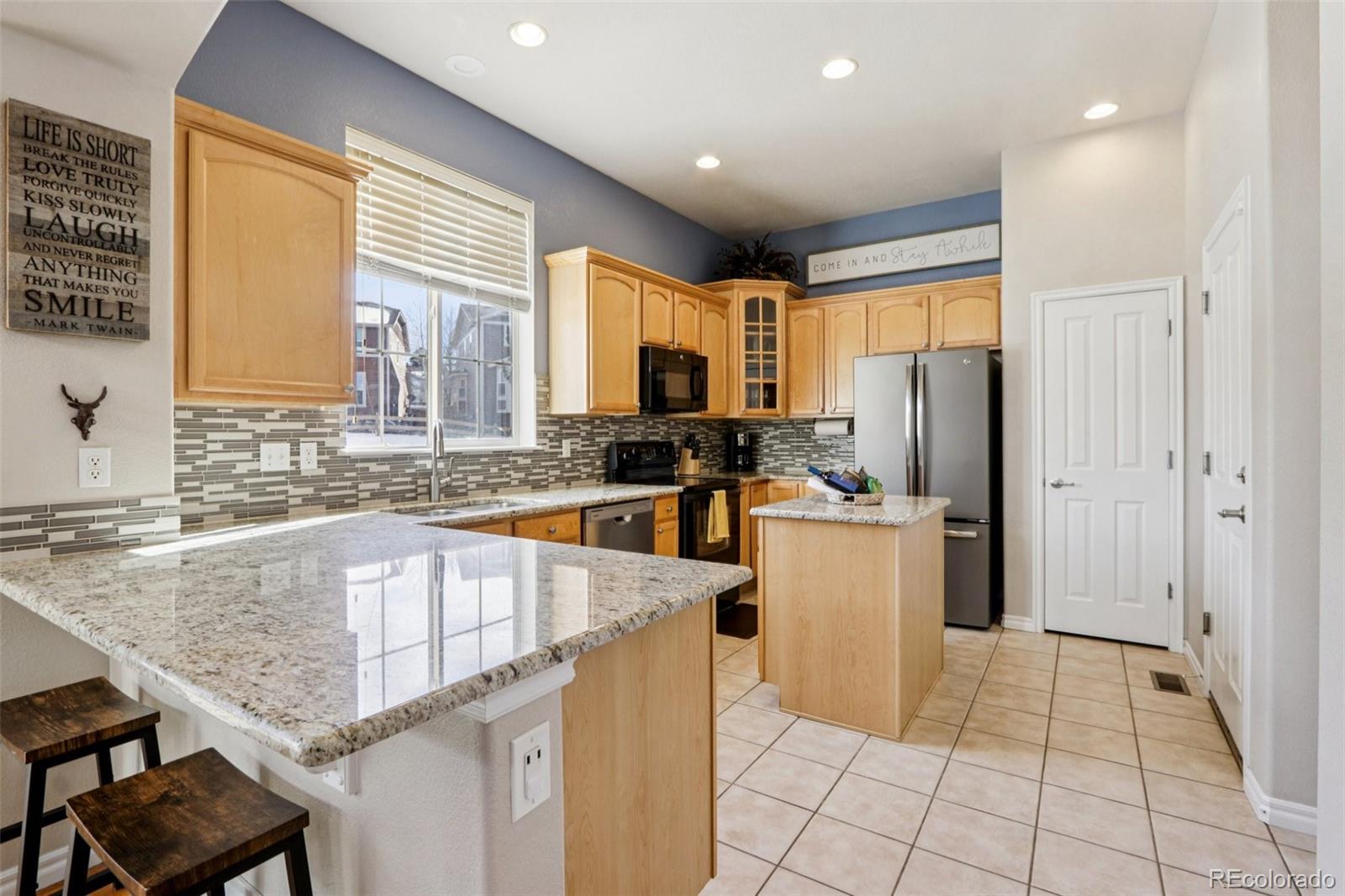 3120 Redhaven Way Highlands Ranch, CO 80126 - Photo 8 of 50 a kitchen with a sink a counter top space and stainless steel appliances
