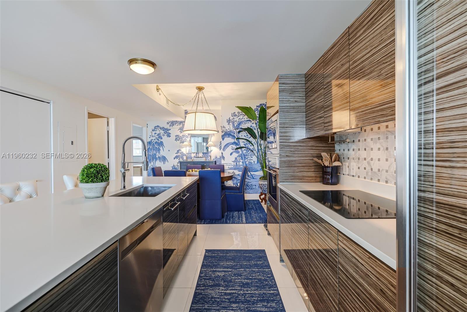 460 Northeast 28th Street, Unit 704 Miami, FL 33137 - Photo 15 of 53 a kitchen with granite countertop a sink and stove in it