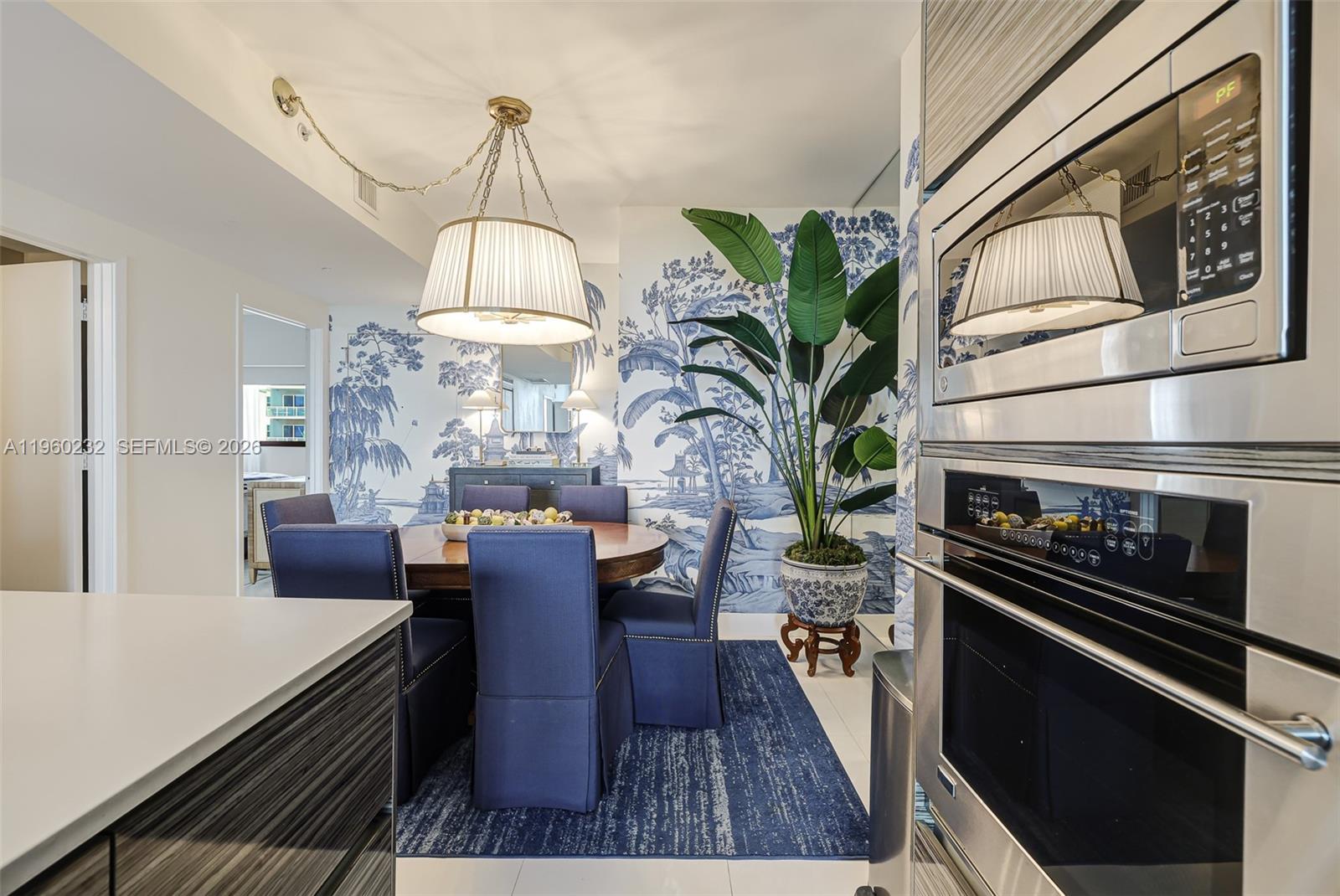 460 Northeast 28th Street, Unit 704 Miami, FL 33137 - Photo 19 of 53 a dining room with furniture a chandelier and wooden floor