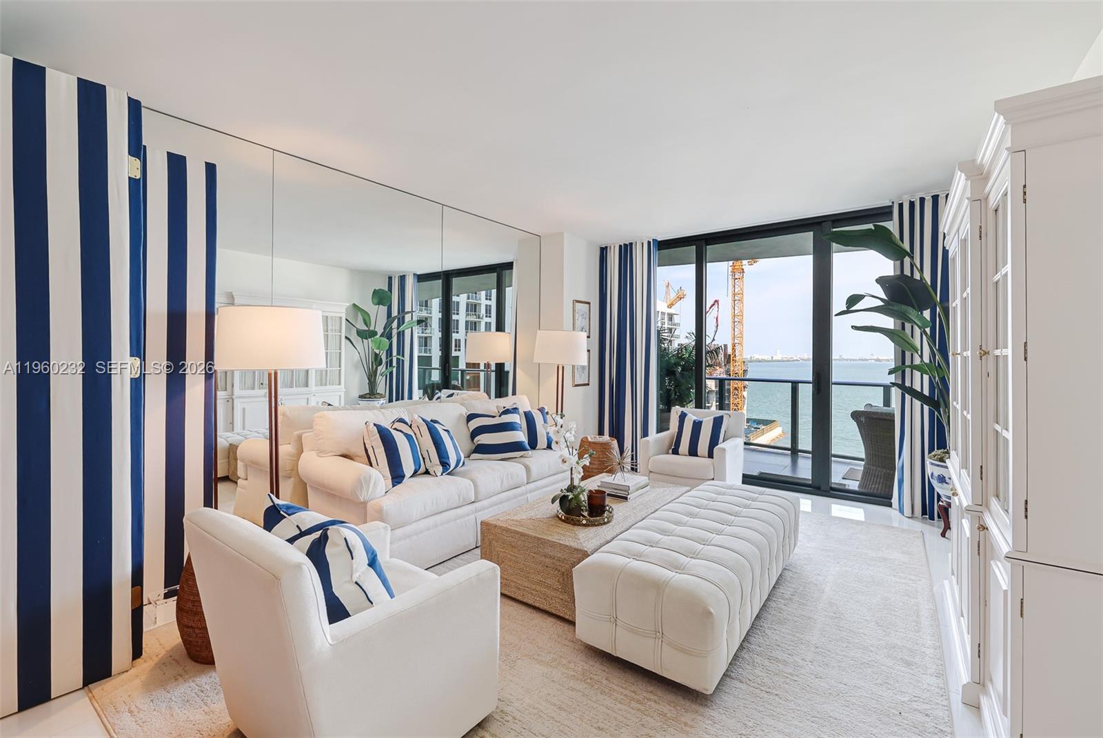 460 Northeast 28th Street, Unit 704 Miami, FL 33137 - Photo 2 of 53 a spacious bedroom with a bed couch and a large window