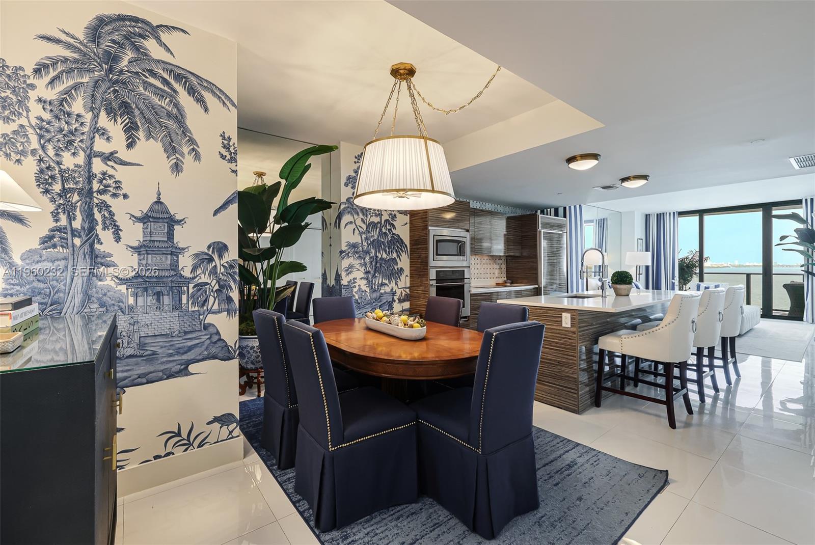 460 Northeast 28th Street, Unit 704 Miami, FL 33137 - Photo 22 of 53 a view of a dining room with furniture and chandelier