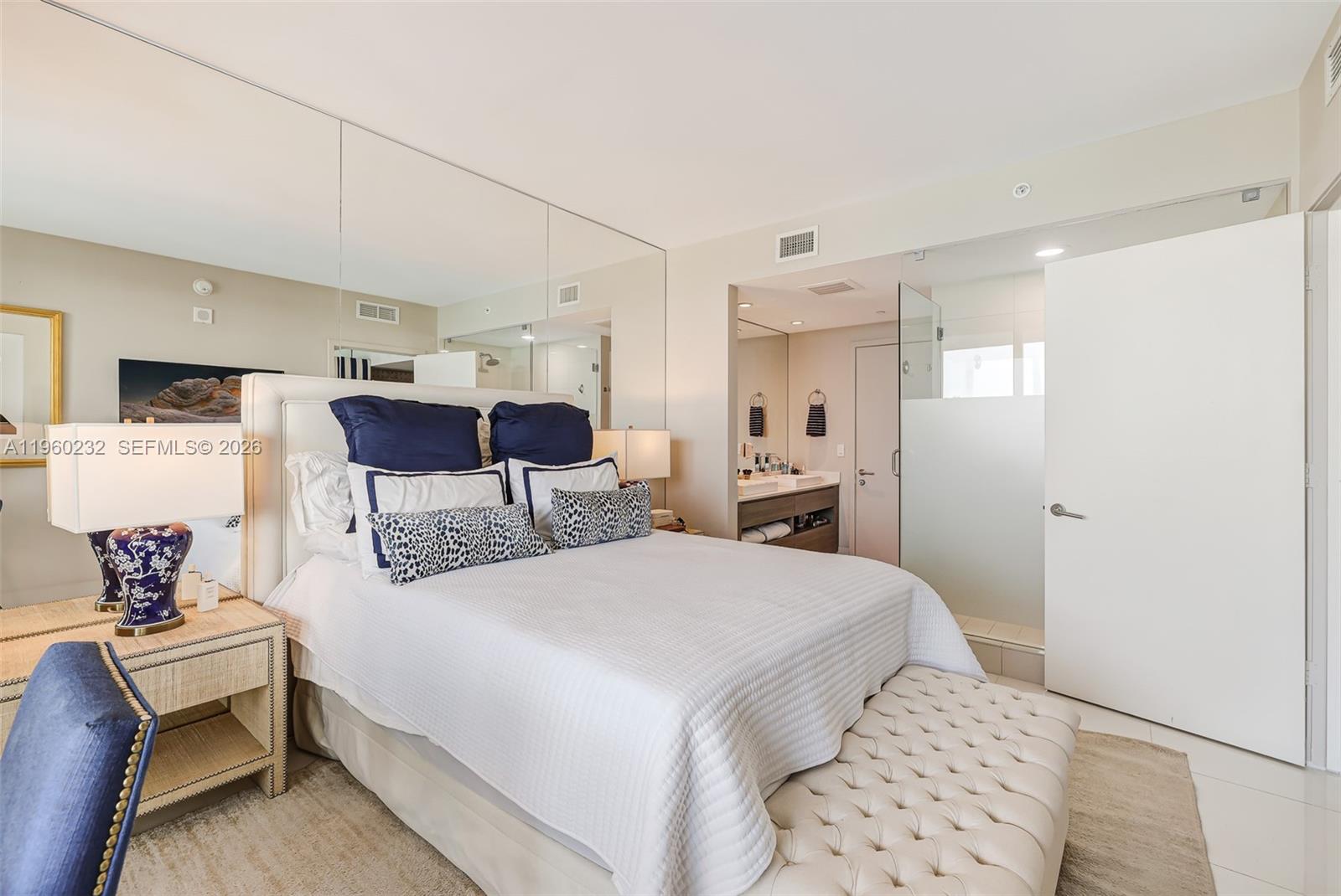 460 Northeast 28th Street, Unit 704 Miami, FL 33137 - Photo 24 of 53 a large bedroom with a bed and wooden floor