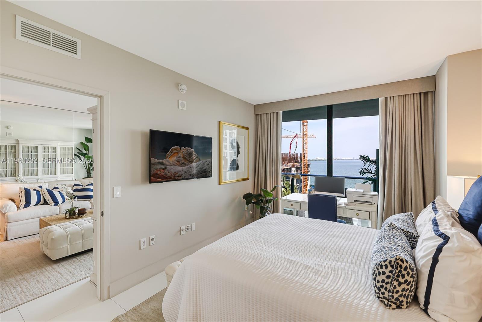 460 Northeast 28th Street, Unit 704 Miami, FL 33137 - Photo 25 of 53 a bedroom with a large bed and a large window