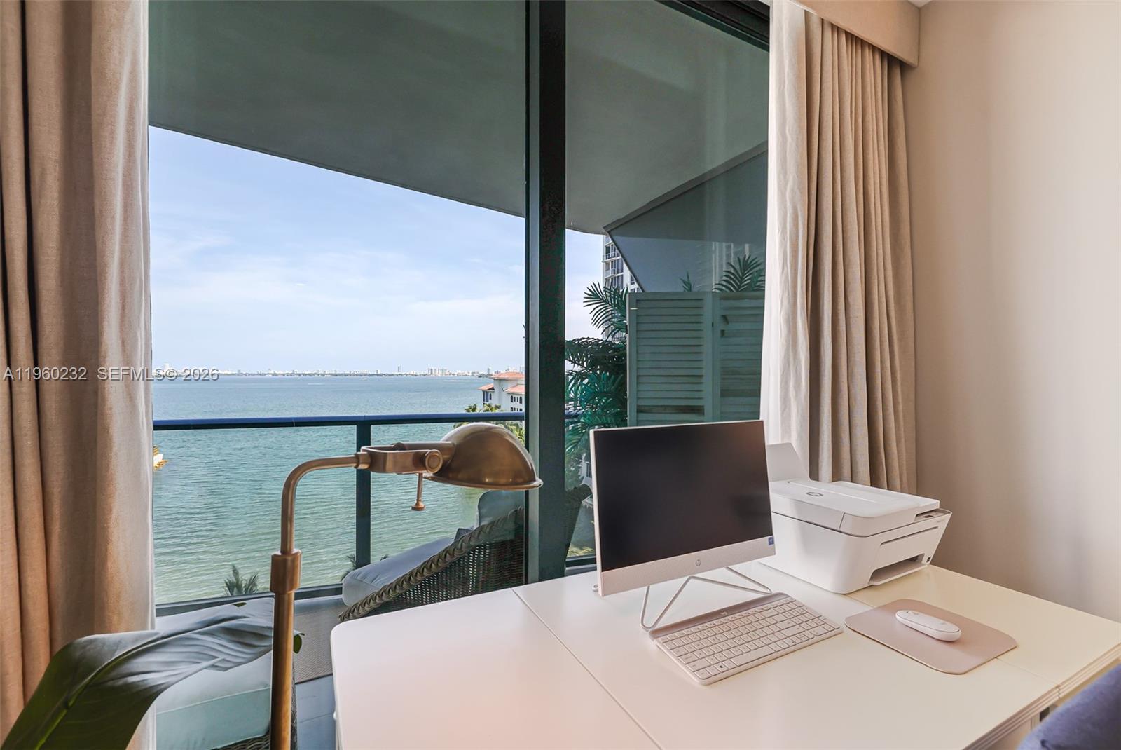 460 Northeast 28th Street, Unit 704 Miami, FL 33137 - Photo 27 of 53 a view of a balcony with chair and floor to ceiling window