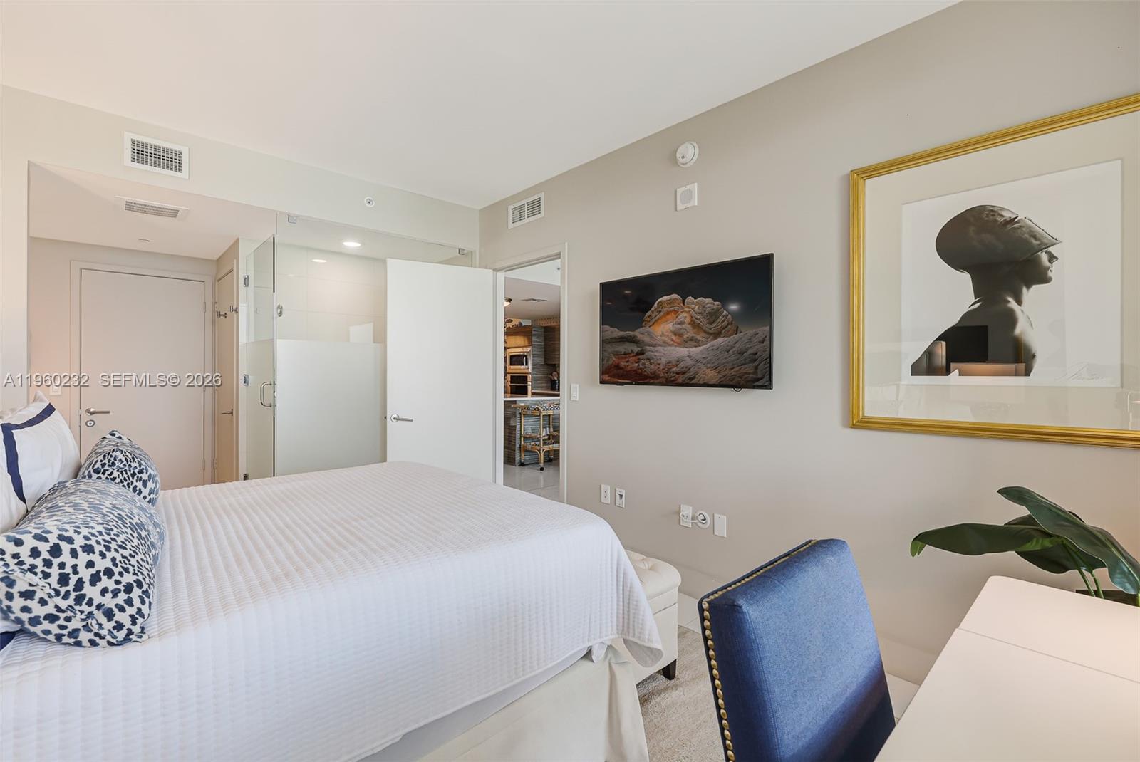 460 Northeast 28th Street, Unit 704 Miami, FL 33137 - Photo 29 of 53 a bedroom with a bed and wall painting