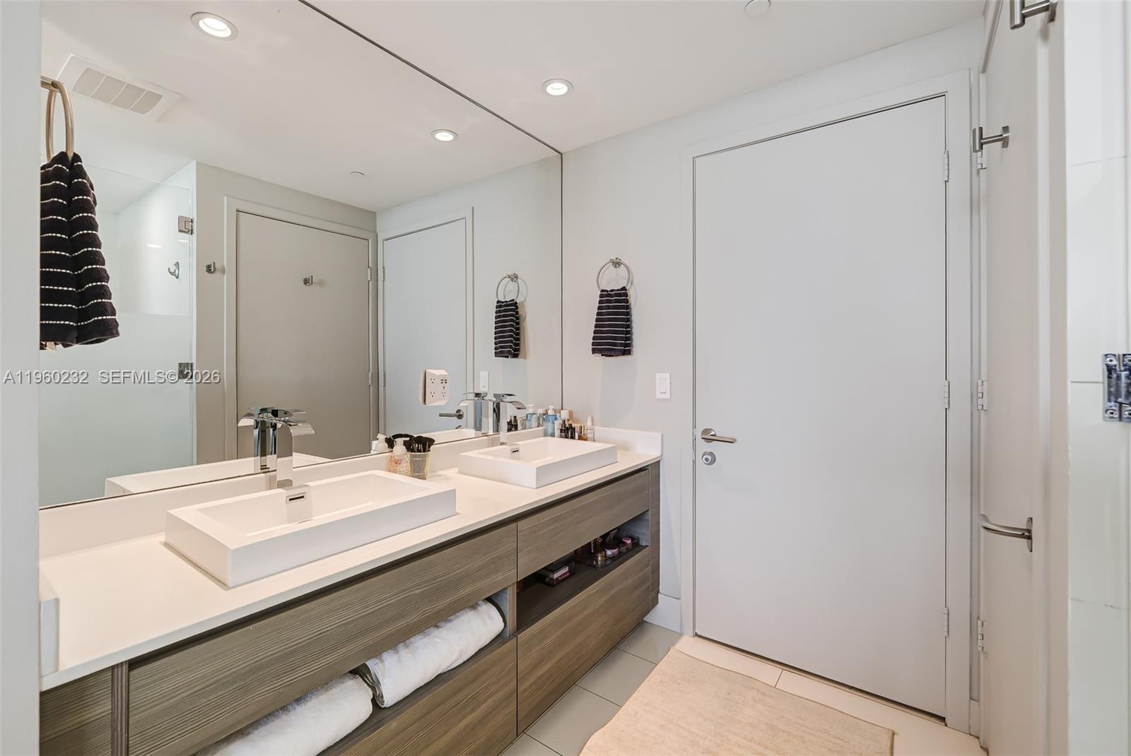 460 Northeast 28th Street, Unit 704 Miami, FL 33137 - Photo 30 of 53 a bathroom with a sink and a mirror