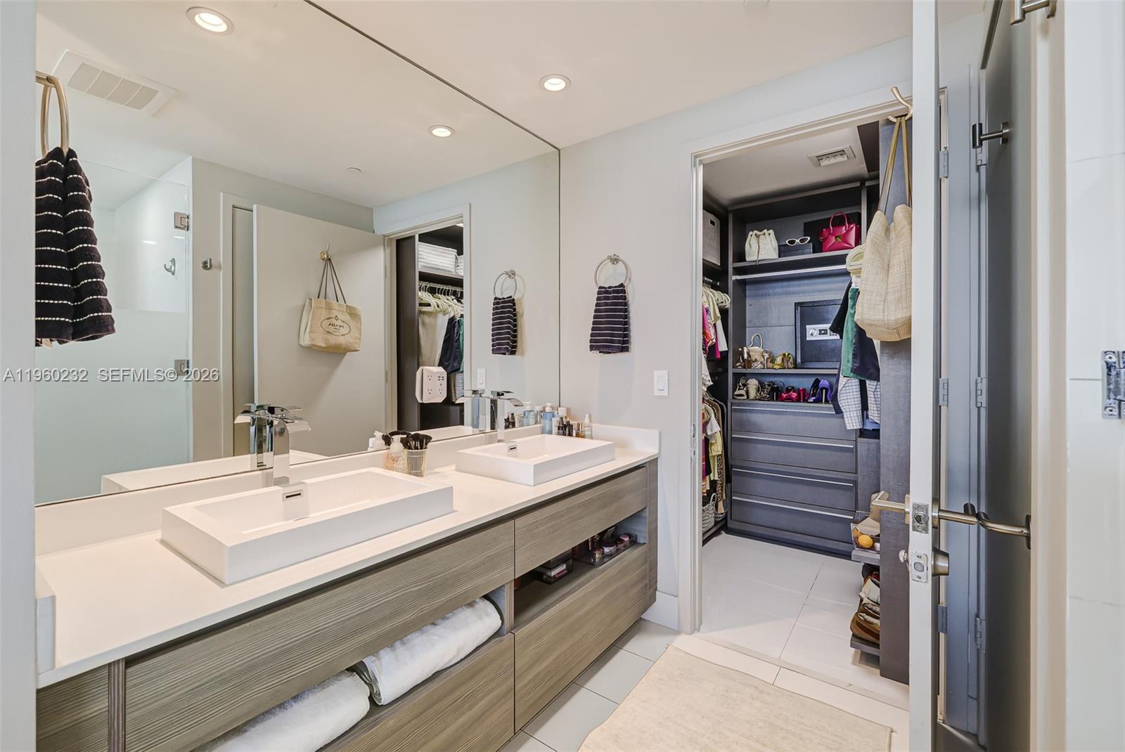 460 Northeast 28th Street, Unit 704 Miami, FL 33137 - Photo 31 of 53 a bathroom with a sink double vanity and a mirror