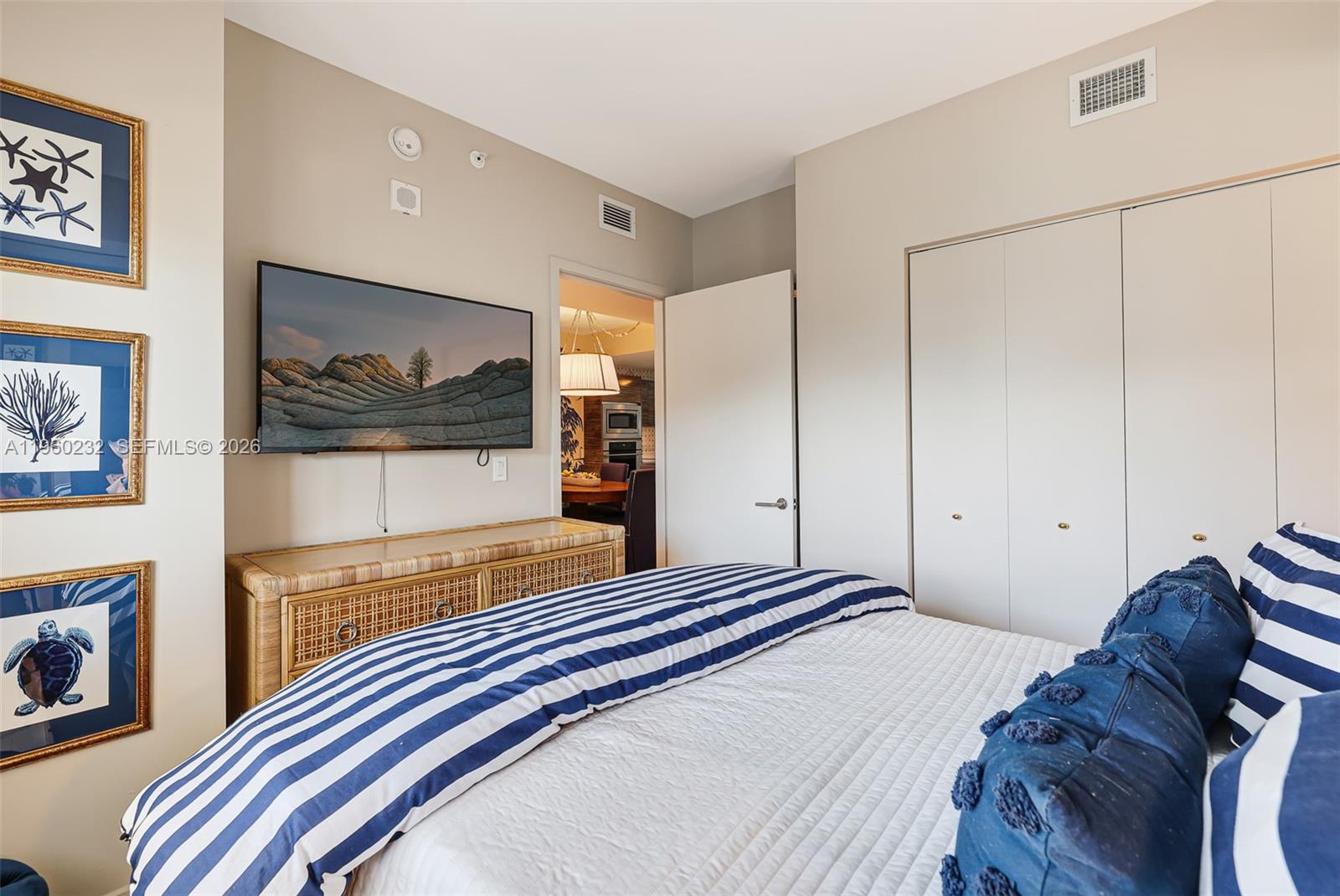 460 Northeast 28th Street, Unit 704 Miami, FL 33137 - Photo 36 of 53 a bedroom with a bed and a painting on the wall