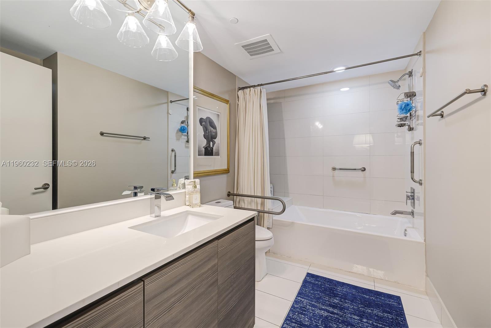 460 Northeast 28th Street, Unit 704 Miami, FL 33137 - Photo 37 of 53 a bathroom with a bathtub shower sink and mirror