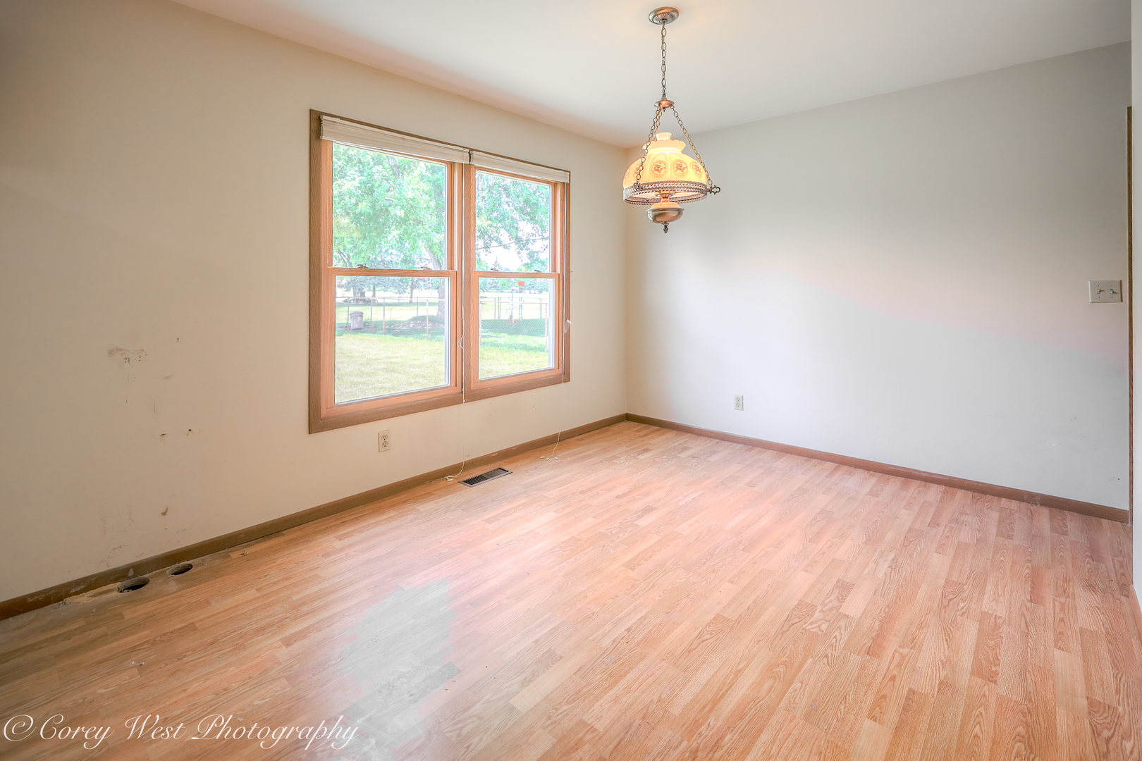 335 South Hadsall Street Genoa, IL 60135 - Photo 11 of 23 an empty room with wooden floor and windows