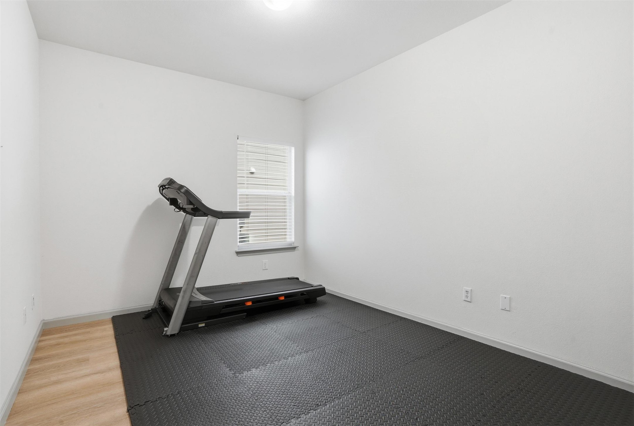 11606 Murchison Street Manor, TX 78653 - Photo 25 of 35 This versatile room is currently used as a workout room featuring exercise puzzle mats that are easily removed. Underneath is LVP flooring.
