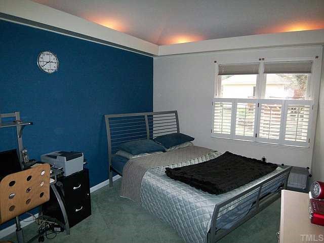 3320 Mill Run Raleigh, NC 27612 - Photo 3 of 10 a bedroom with a bed and a window