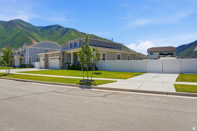 1165 West Union Bench Drive Mapleton, UT 84664 - Photo 60 of 61 Contemporary residence featuring a stone and siding exterior, a front porch, and an attached two-car garage