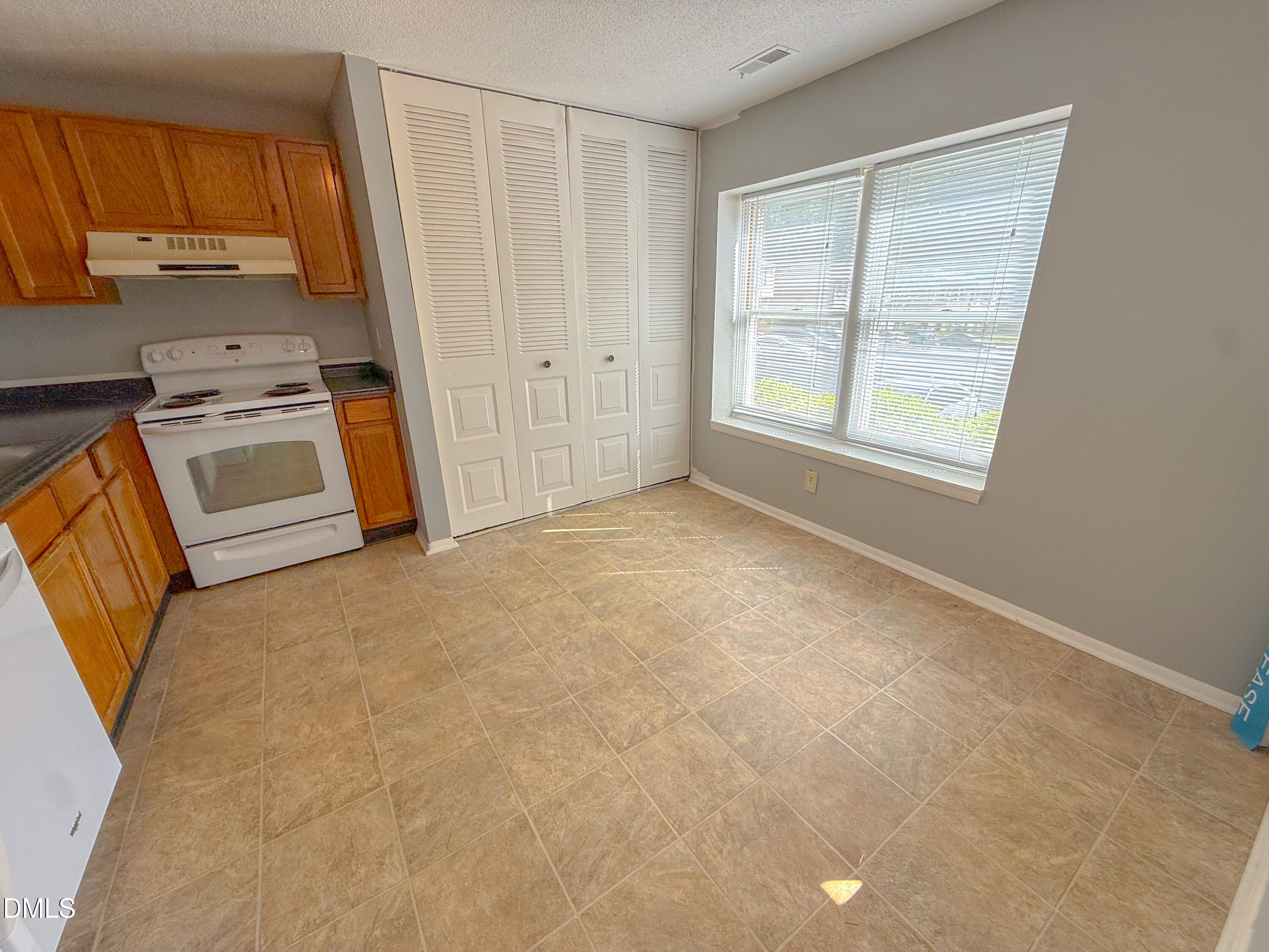 7718 Kelley Court Raleigh, NC 27615 - Photo 3 of 13 a view of a kitchen with an empty space and a window