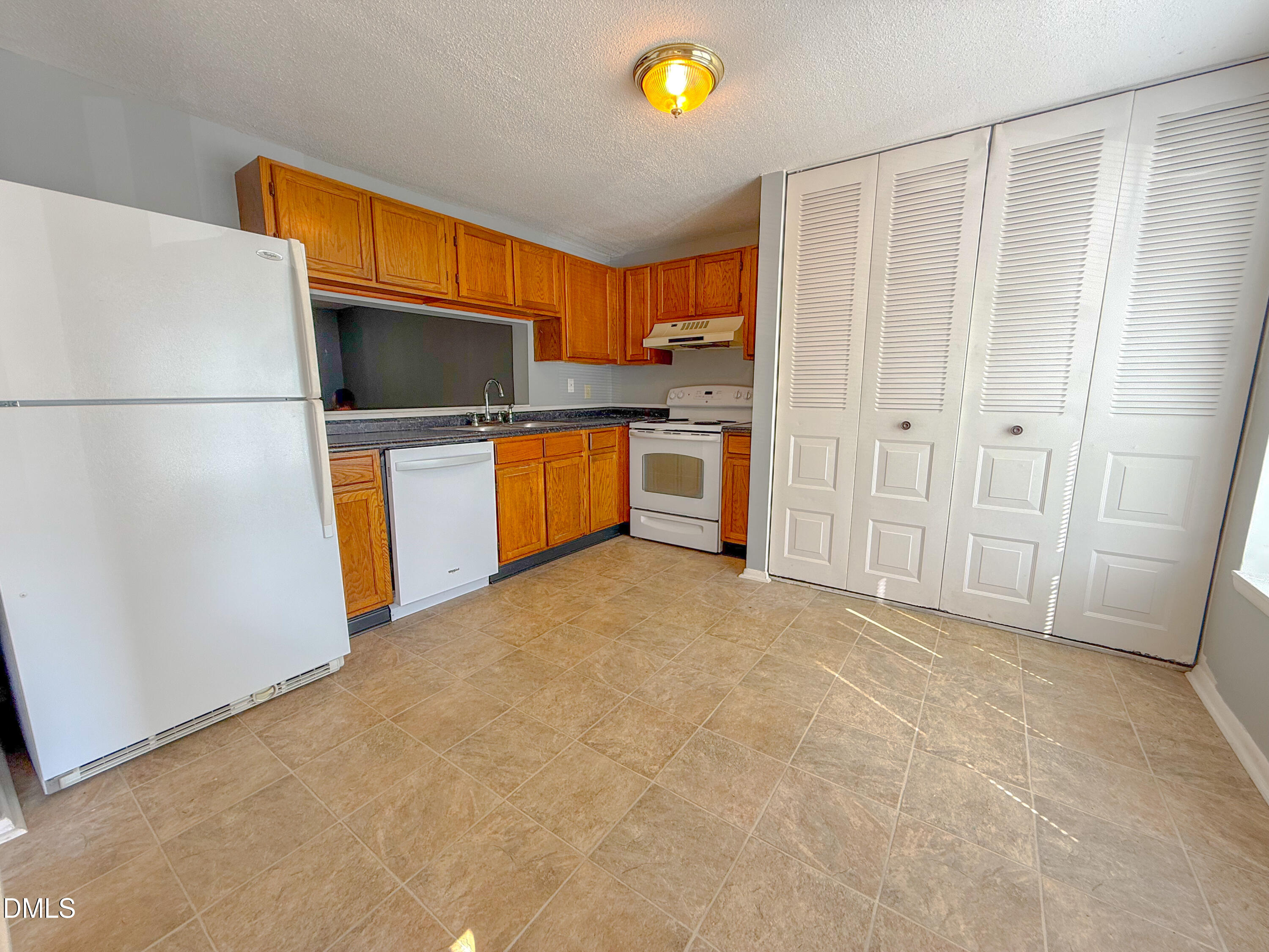 7718 Kelley Court Raleigh, NC 27615 - Photo 4 of 13 a kitchen with stainless steel appliances a refrigerator and a microwave