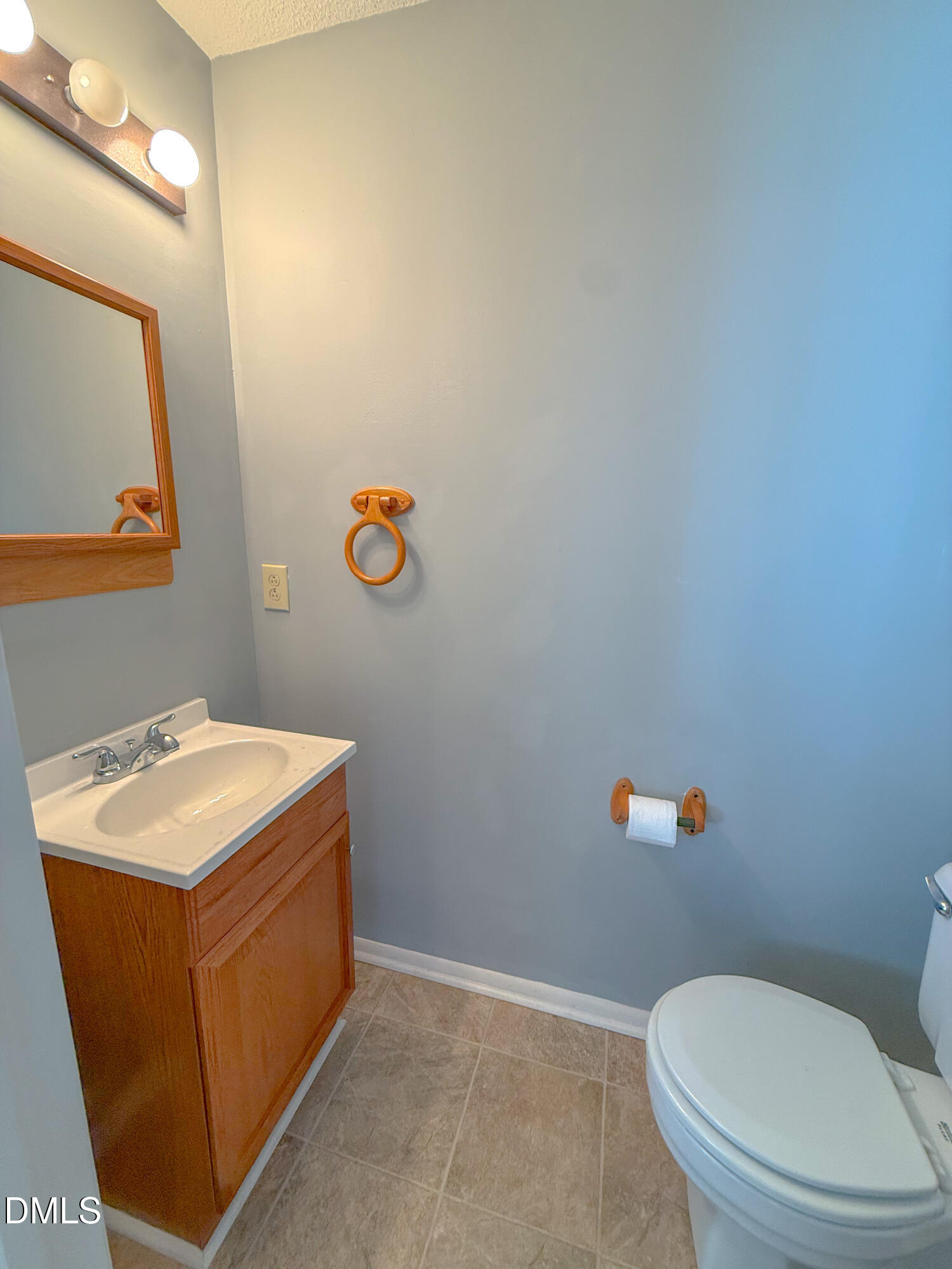7718 Kelley Court Raleigh, NC 27615 - Photo 7 of 13 a bathroom with a toilet a sink and mirror