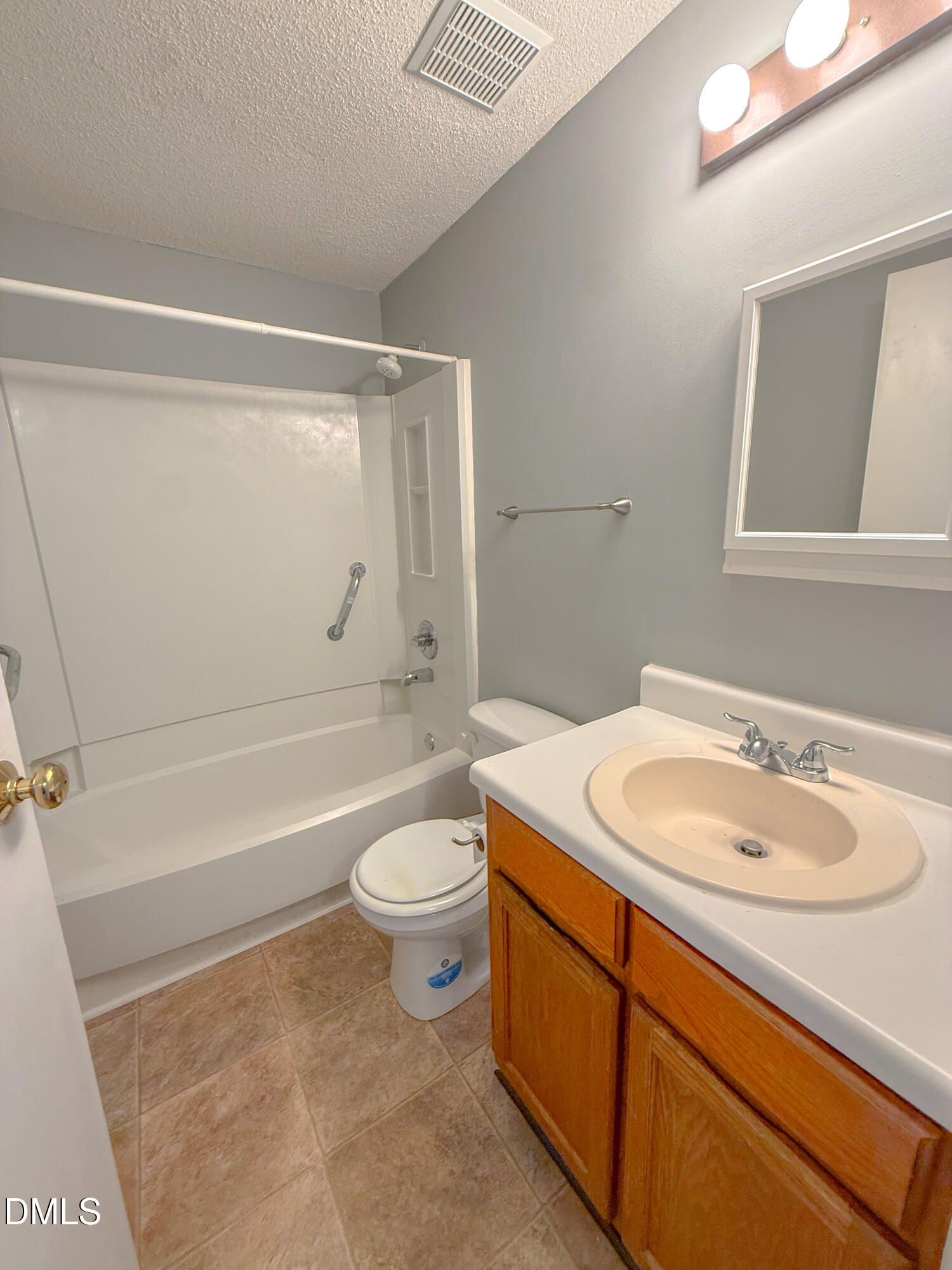 7718 Kelley Court Raleigh, NC 27615 - Photo 10 of 13 a bathroom with a sink a toilet and a bathtub