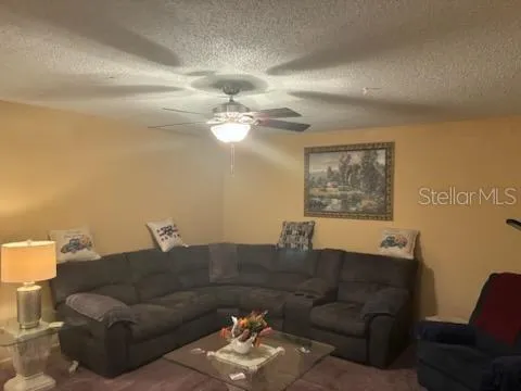 a living room with furniture and a lamp