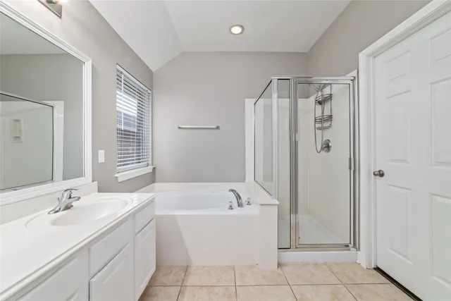 a bathroom with a tub sink and mirror
