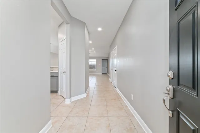 a view of hallway with a large window and a hallway