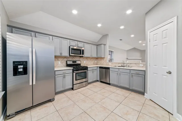 a kitchen with a refrigerator sink and microwave