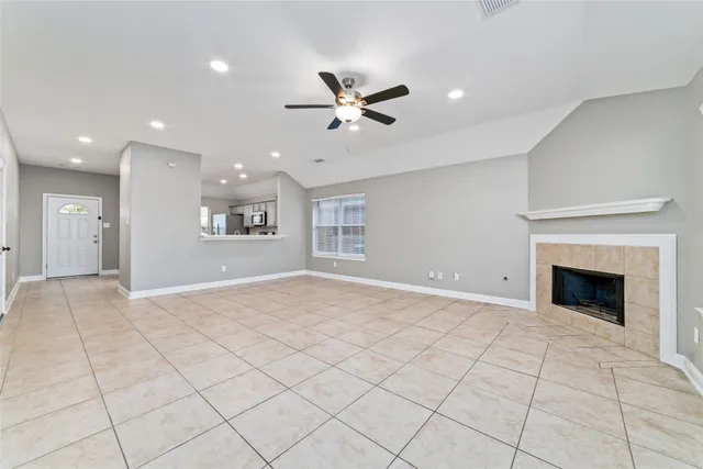 a view of an empty room and kitchen view