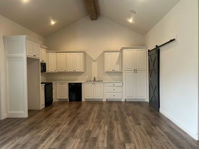 a kitchen with stainless steel appliances a refrigerator and a stove top oven