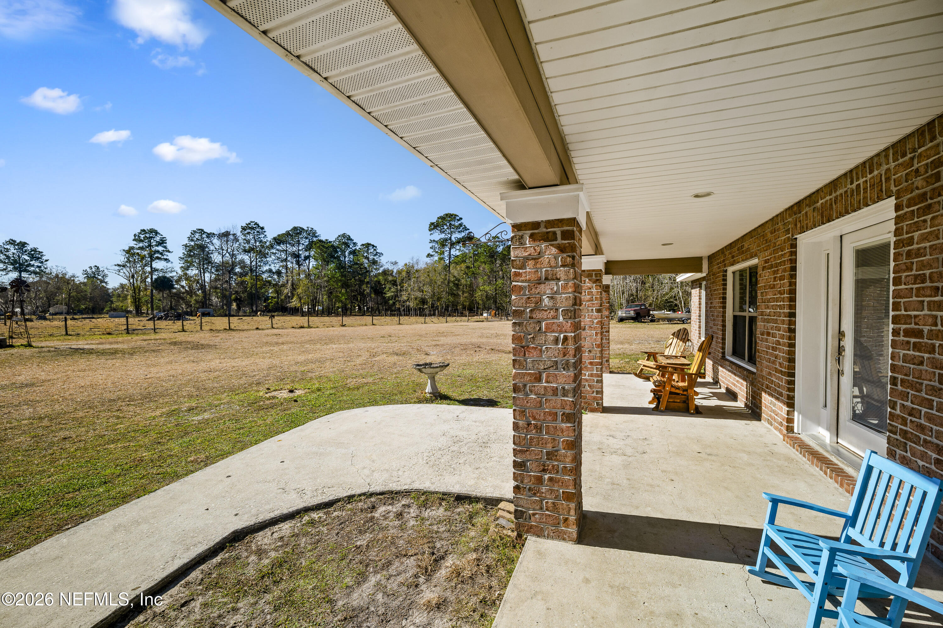 1725 Davidson Farm Road Jacksonville, FL 32218 - Photo 15 of 55 a view of a patio with lawn chairs floor to ceiling window and yard