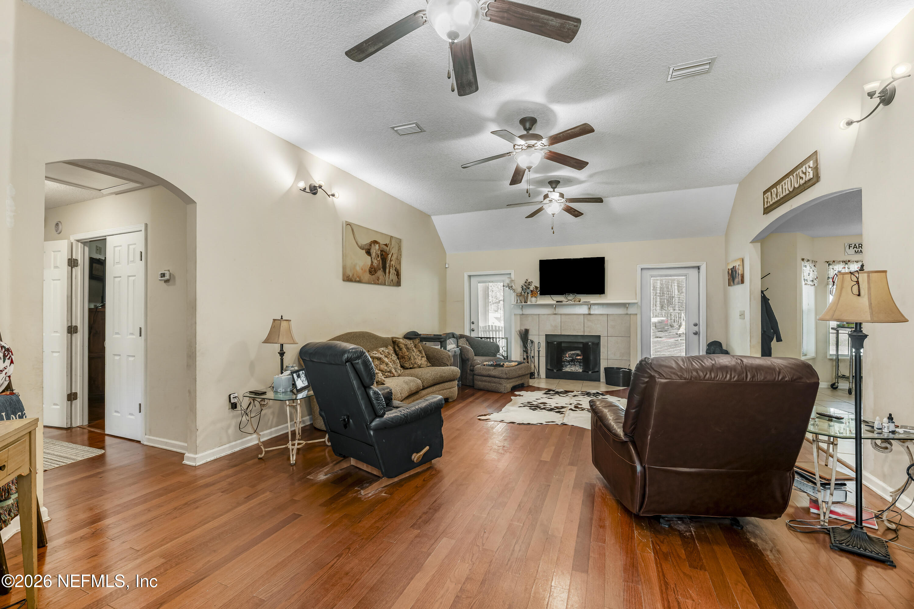 1725 Davidson Farm Road Jacksonville, FL 32218 - Photo 18 of 55 a living room with furniture fireplace and flat screen tv