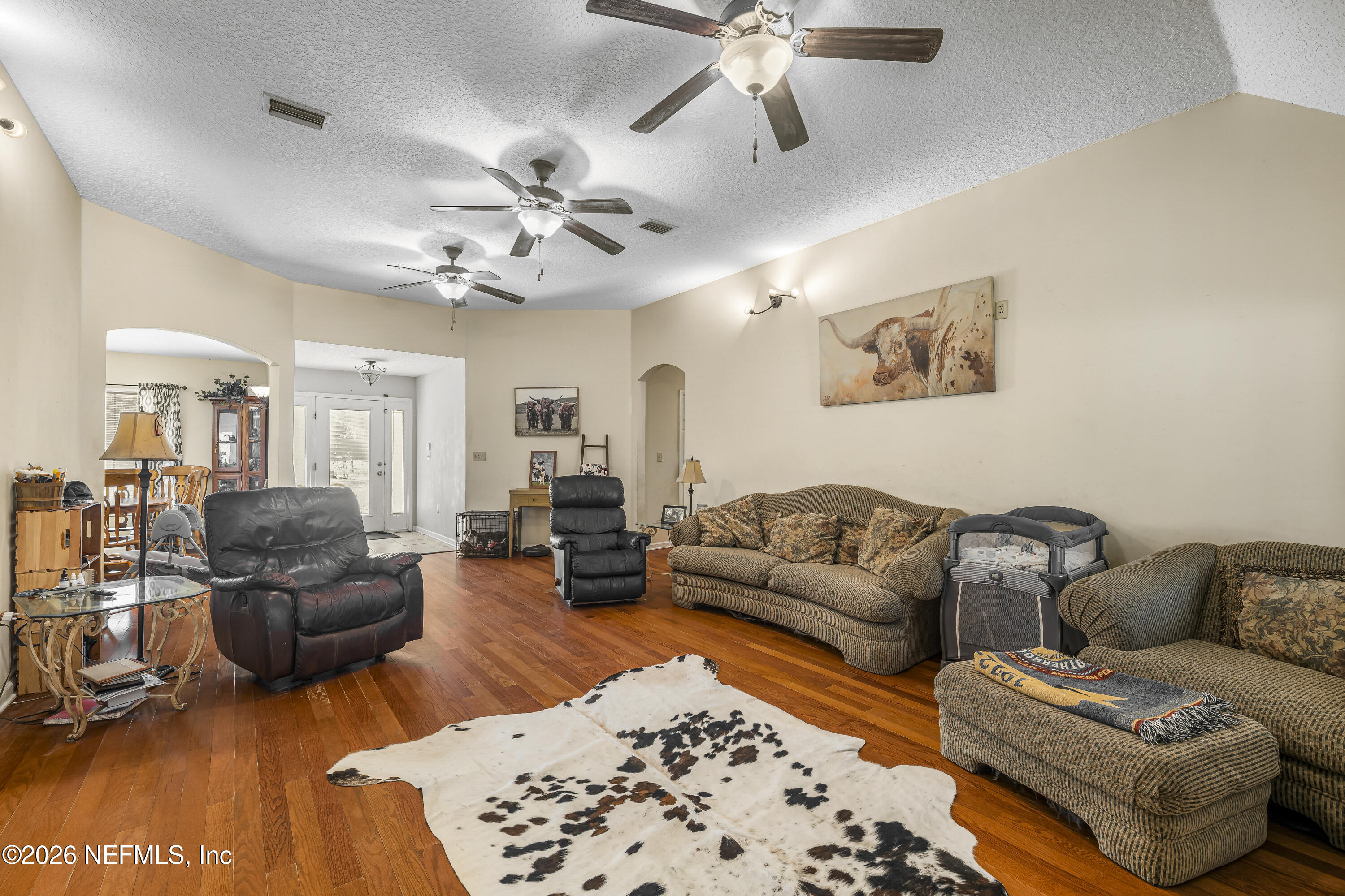 1725 Davidson Farm Road Jacksonville, FL 32218 - Photo 21 of 55 a living room with furniture and a chandelier