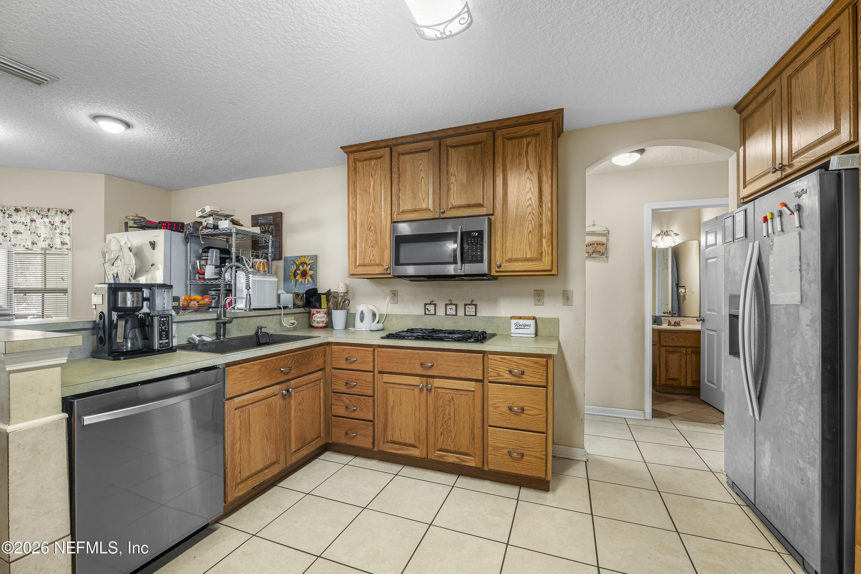 1725 Davidson Farm Road Jacksonville, FL 32218 - Photo 26 of 55 a kitchen with stainless steel appliances granite countertop a refrigerator and a sink