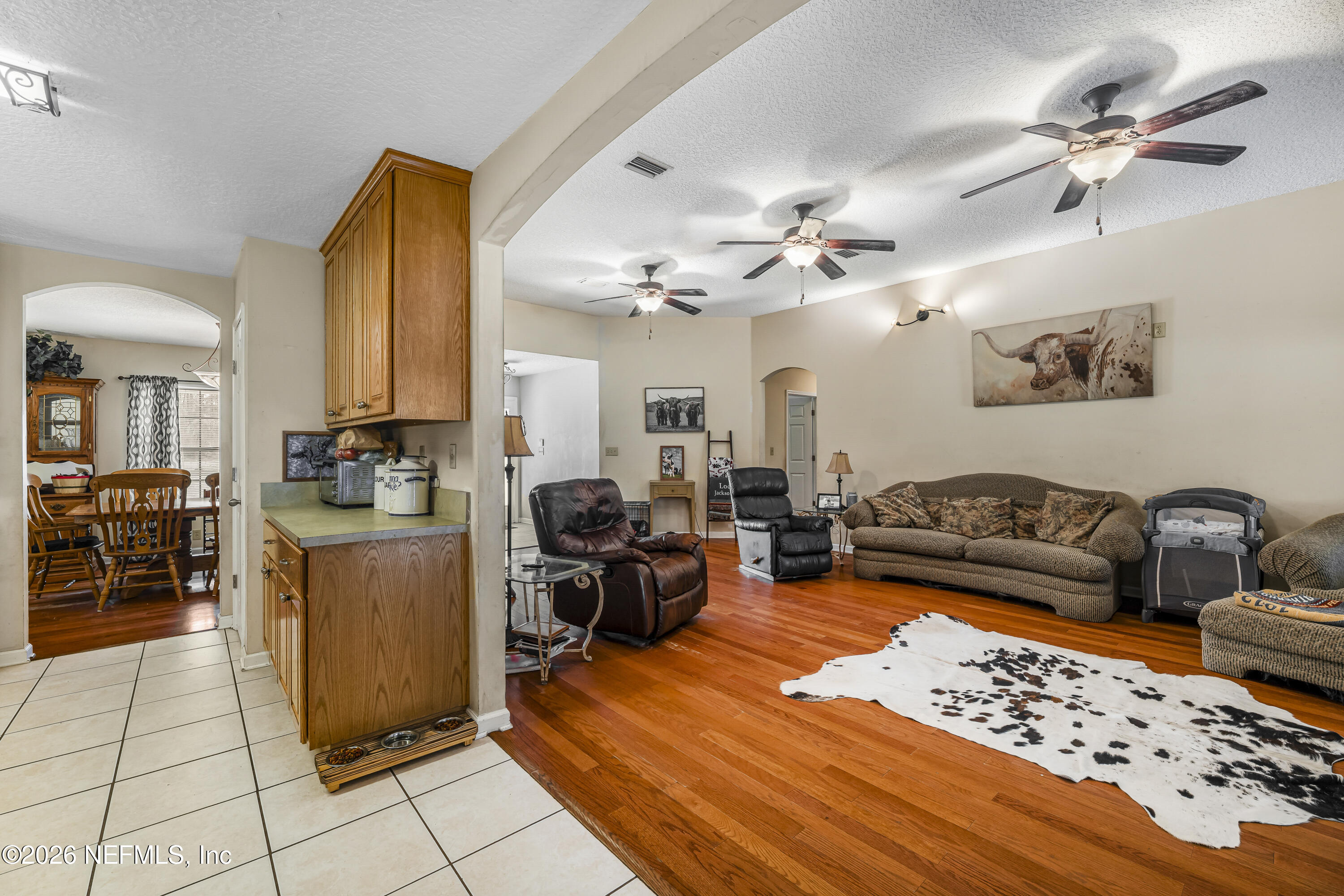 1725 Davidson Farm Road Jacksonville, FL 32218 - Photo 32 of 55 a living room with furniture and a chandelier