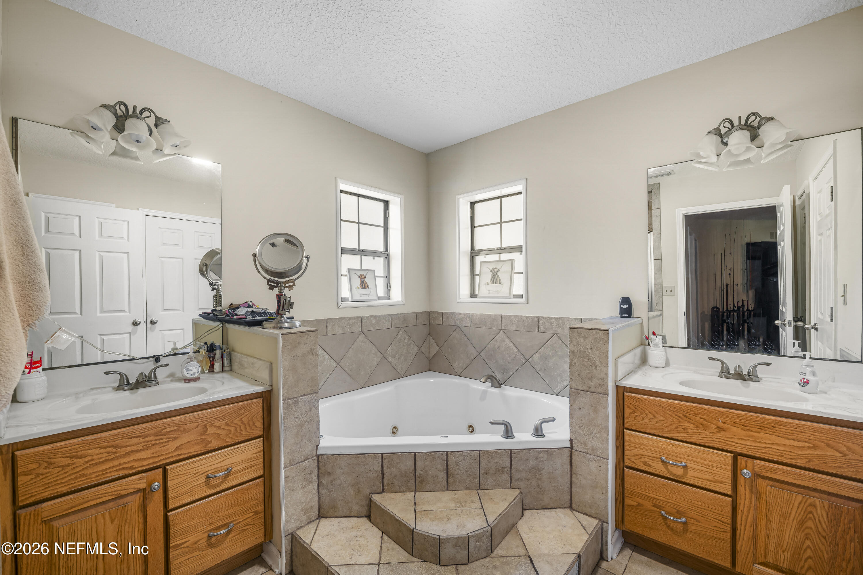 1725 Davidson Farm Road Jacksonville, FL 32218 - Photo 35 of 55 a bathroom with a granite countertop sink mirror and bathtub