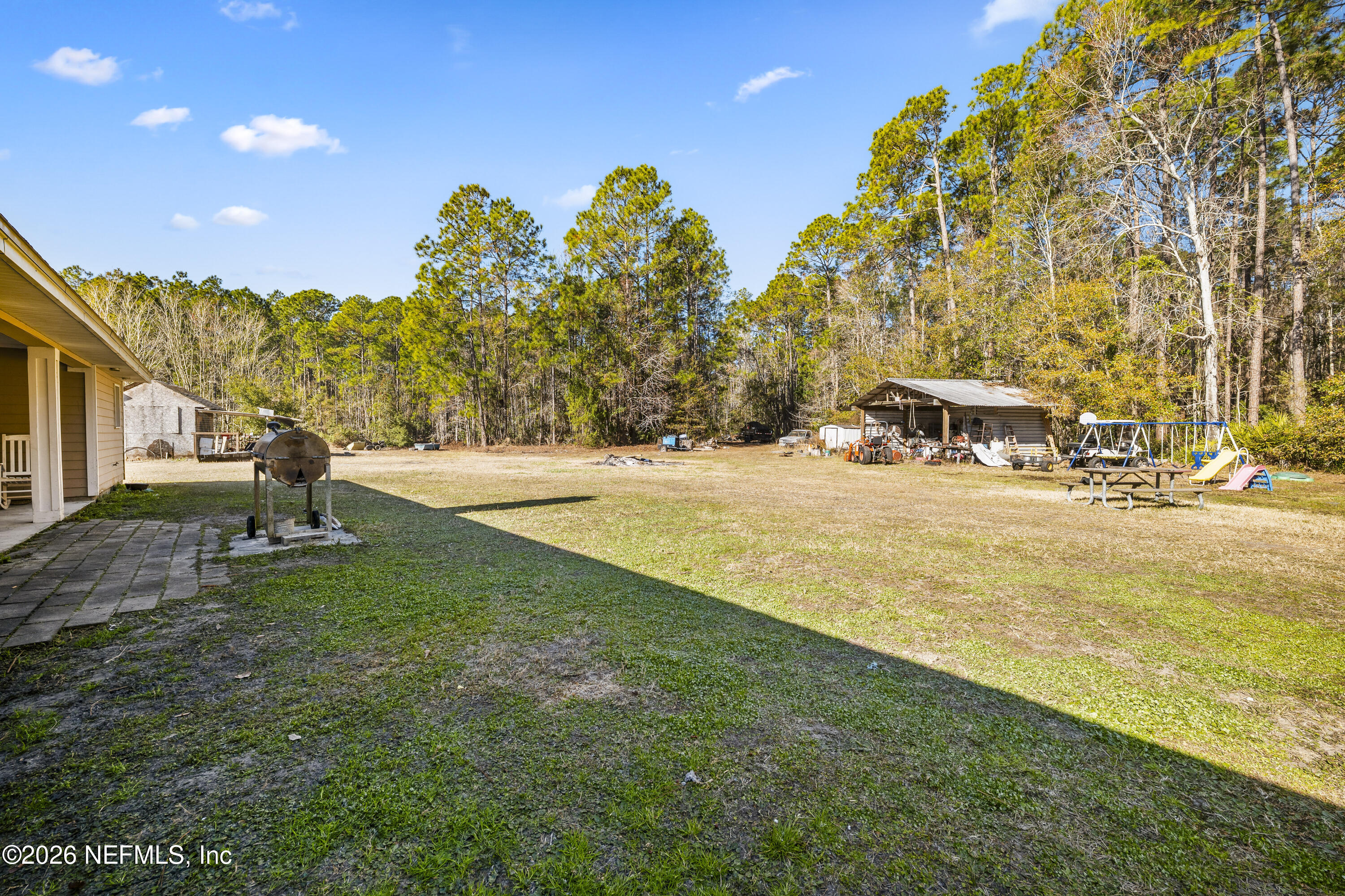 1725 Davidson Farm Road Jacksonville, FL 32218 - Photo 47 of 55 a view of yard with swimming pool and trees