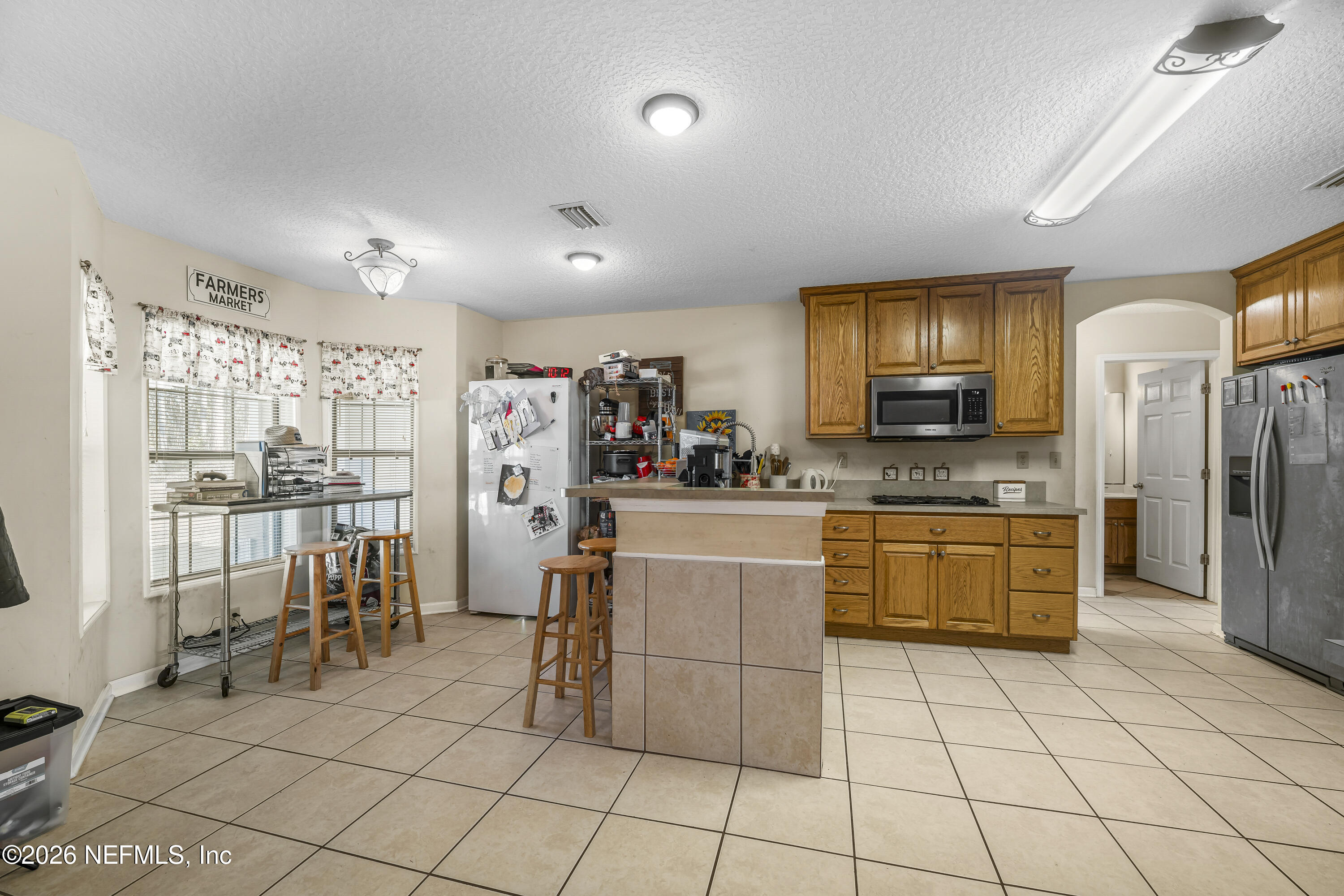 1725 Davidson Farm Road Jacksonville, FL 32218 - Photo 5 of 55 a kitchen with cabinets and chairs